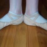 image of caucasuion feet in ballet first position from the ankle down