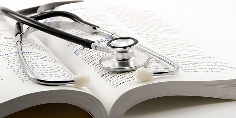 image of stethoscope laying on an open book