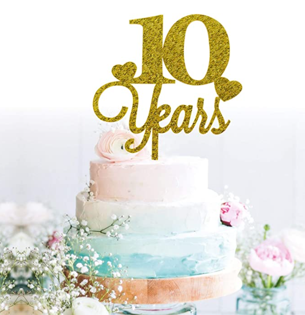 Picture of a three-tier cake in pastel colors with 10 years adorning the top.